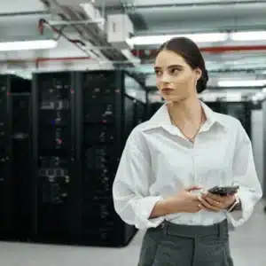 Woman supervises secure data center environment to ensure cyber managed services protect systems