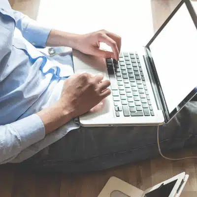 User types on laptop connected by cable monitoring services for lenovo server solutions on the go