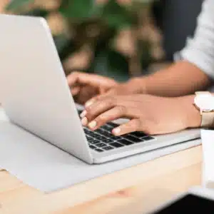 Engineer types on laptop to validate restore process, checking logs and verifying data integrity success