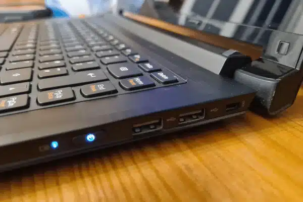 Closeup of laptop ports and keyboard on desk showing hardware for lenovo vs dell servers
