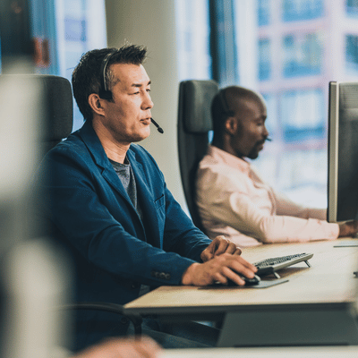 Headset agent monitors screens in office, providing Remote IT support to resolve user problems